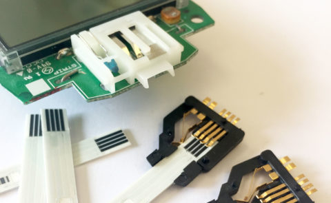 Strip contact assembly block design. In-moulded contacts for diagnostic products